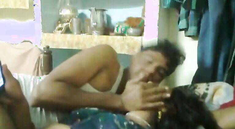 Mumbai raand after sex with her pimp laying watching a porn movie on his mobile who is playing with her boobs.