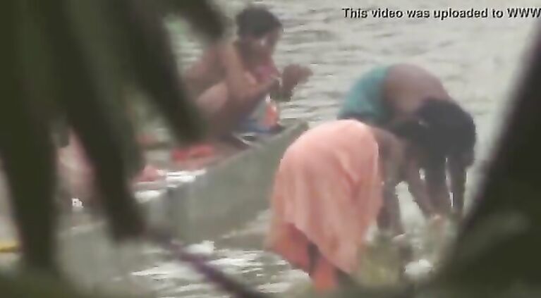 Tamil women bathing by the river